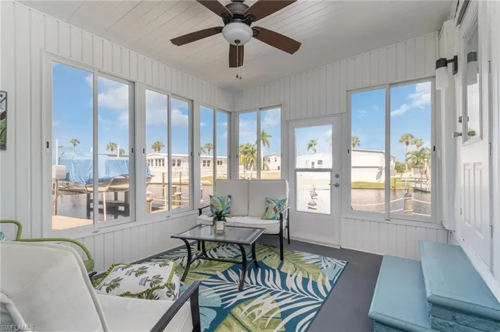 Sunroom featuring an outdoor hangout area, a ceiling fan, and healthy amount of natural light