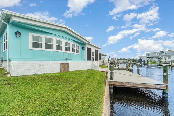 Dock area featuring a water view and a lawn