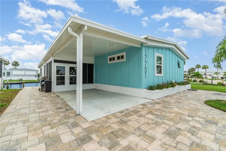 View of property exterior featuring board and batten siding and a patio