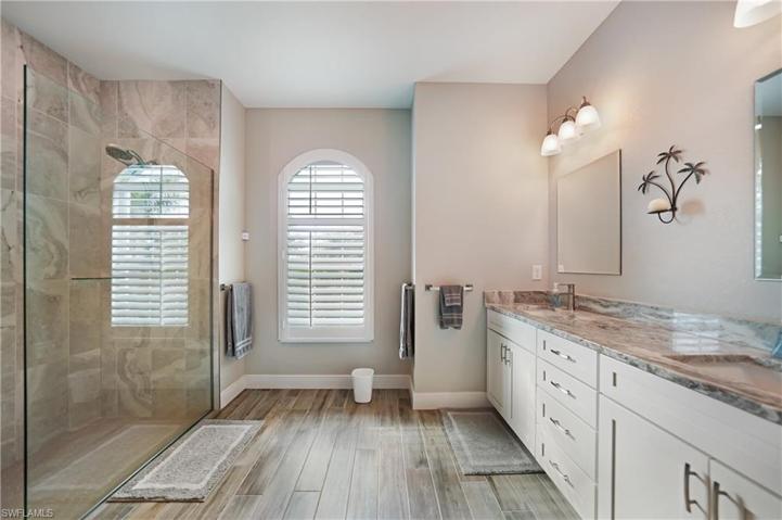 PRIMARY BATH WITH GLASS AND TILE SHOWER