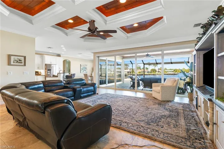 Living room with beam ceiling, wooden ceiling, crown molding, and coffered ceiling