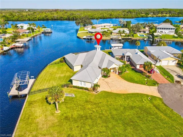 Birds eye view of property with a water view