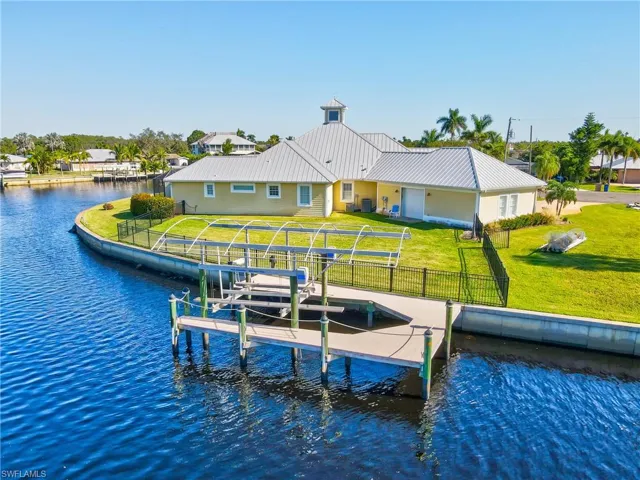 Dock area with a yard and a water view
