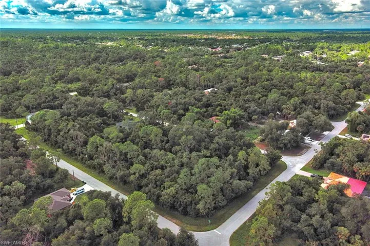 Aerial view of property's location featuring a forest