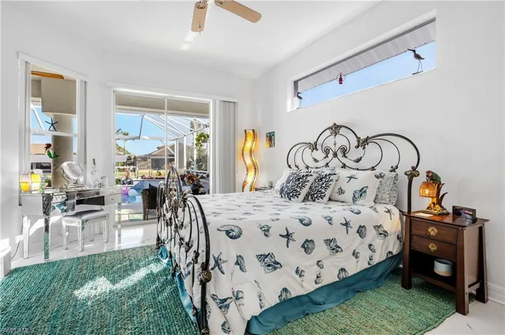 Bedroom featuring a ceiling fan and access to outside