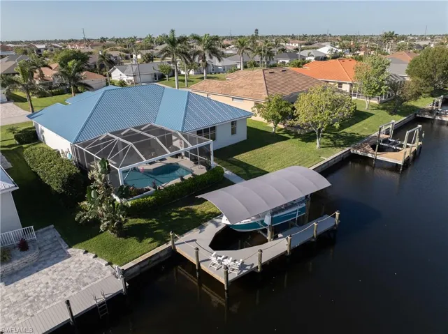 Drone / aerial view with a residential view and a water view