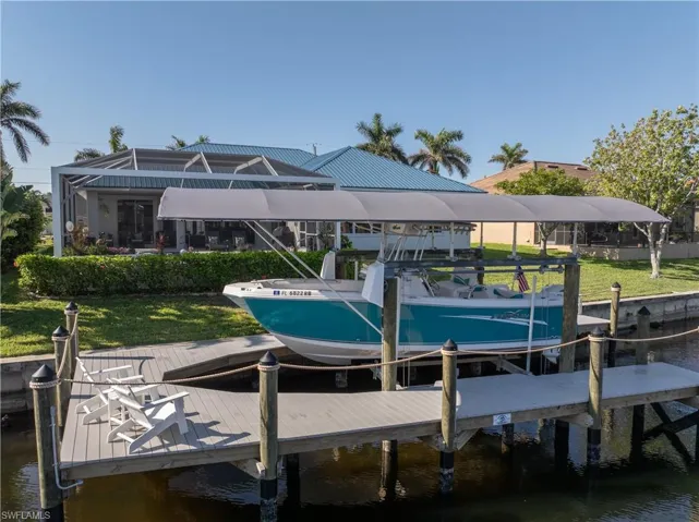 Dock area with a water view and boat lift