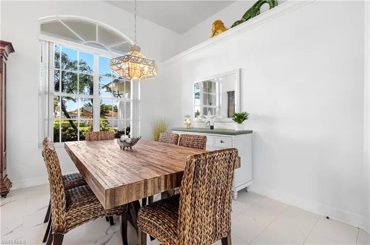 Dining area with baseboards, marble finish floor, and a chandelier