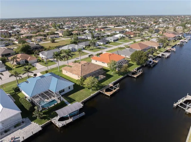 Drone / aerial view with a residential view and a water view