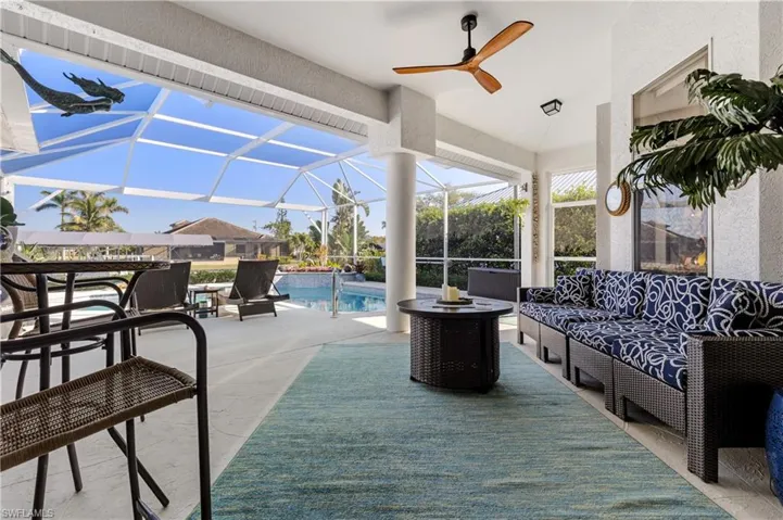 View of patio / terrace with outdoor lounge area, a lanai, an outdoor pool, and a ceiling fan