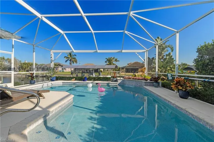 Outdoor pool with a lanai and a patio area