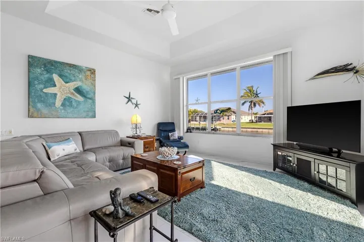 Living room with visible vents and a ceiling fan