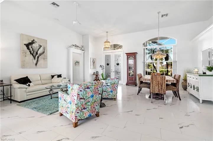 Dock area featuring a water view, a lawn, and boat lift