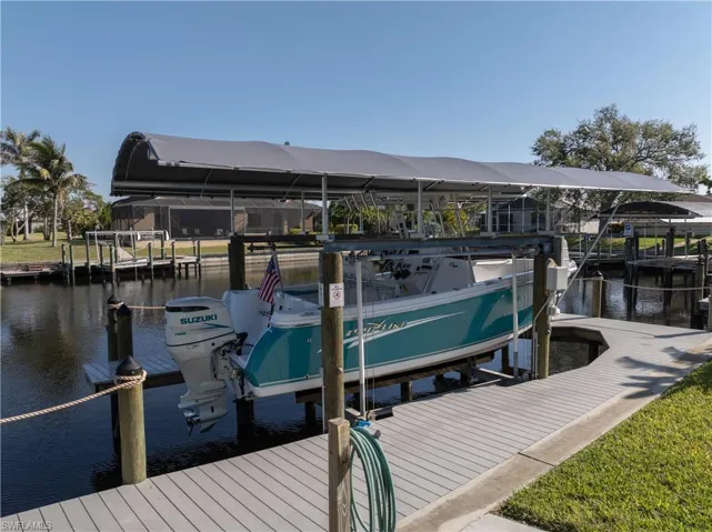 Dock area with boat lift and a water view