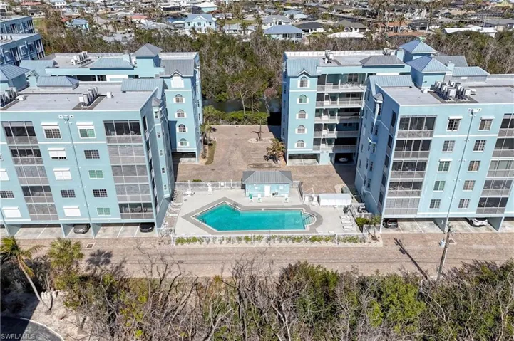 Aerial view of apartment complex / building and a pool