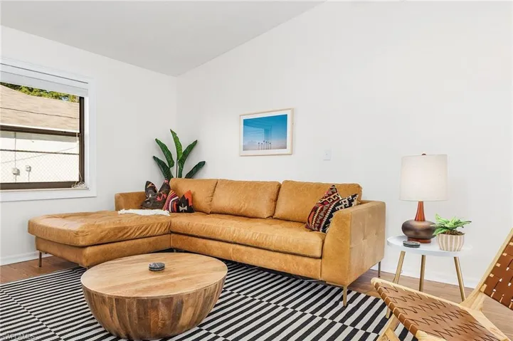 Living area with wood finished floors and vaulted ceiling