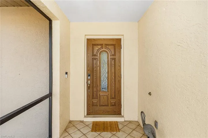 View of exterior entry featuring stucco siding