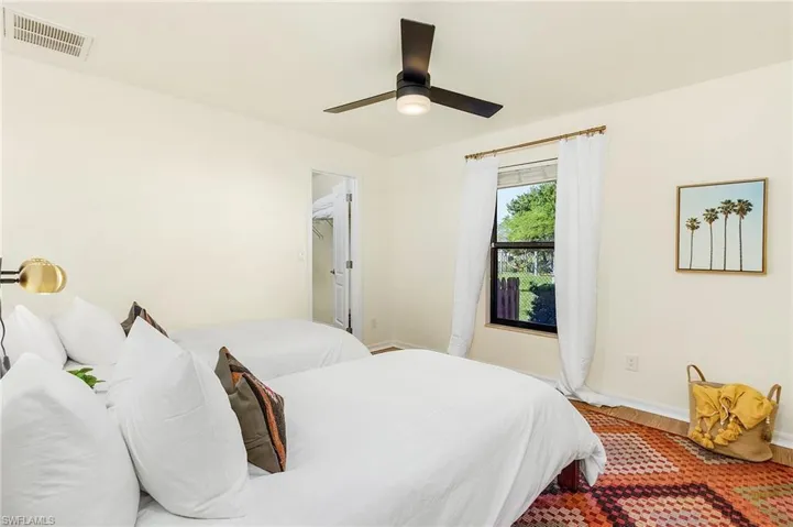 Bedroom with wood finished floors and a ceiling fan