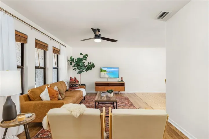 Living room featuring light wood-style flooring and a ceiling fan
