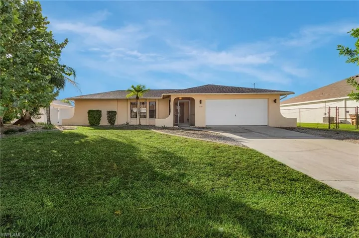 Single story home with stucco siding, concrete driveway, and an attached garage