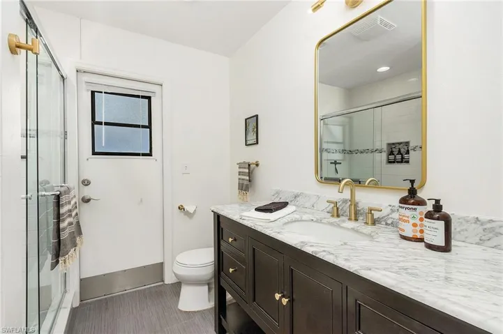 Full bathroom with vanity and an enclosed shower