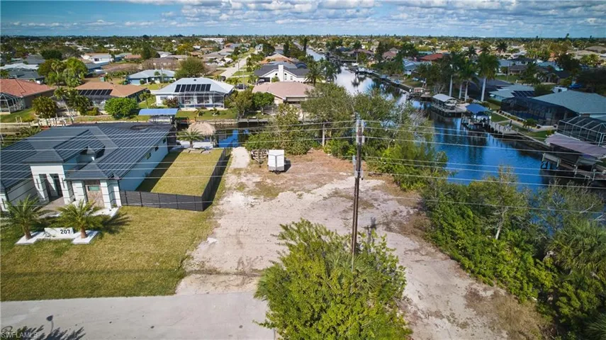 Expansive lot featuring a level terrain, surrounded by established residences, and canal access