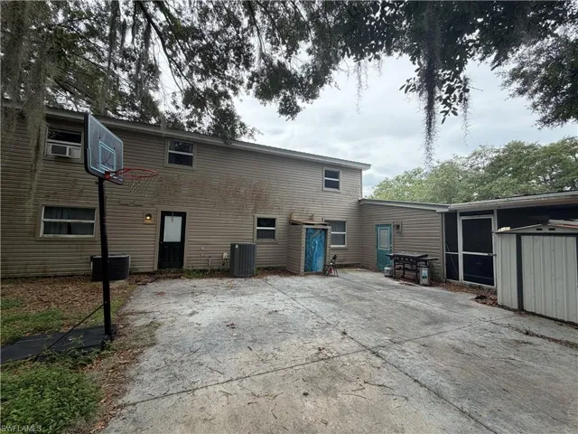 Showing paved area with basketball net and outdoor shower
