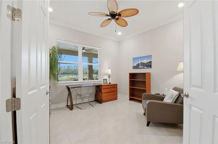 Spacious den with view to the gorgeous lanai, pool and picturesque golf course.