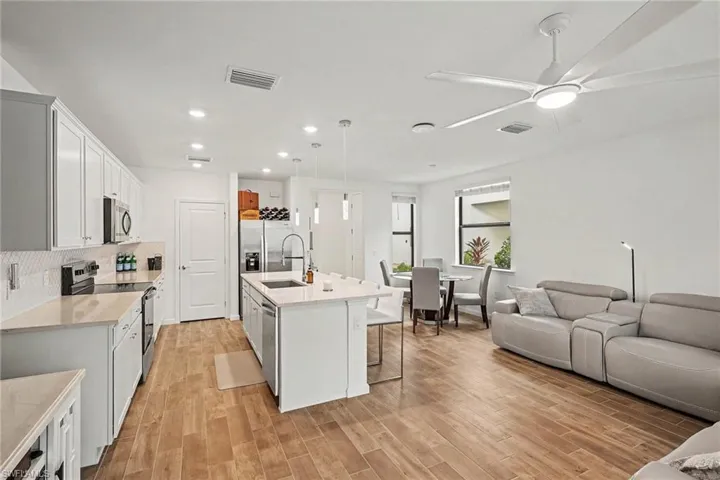 Open-concept living space featuring wood-finish flooring throughout