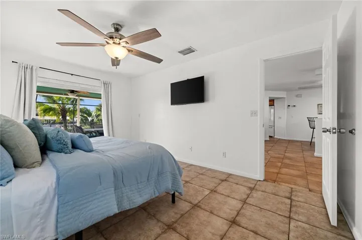 Primary Bedroom has pocketing sliders to the pool