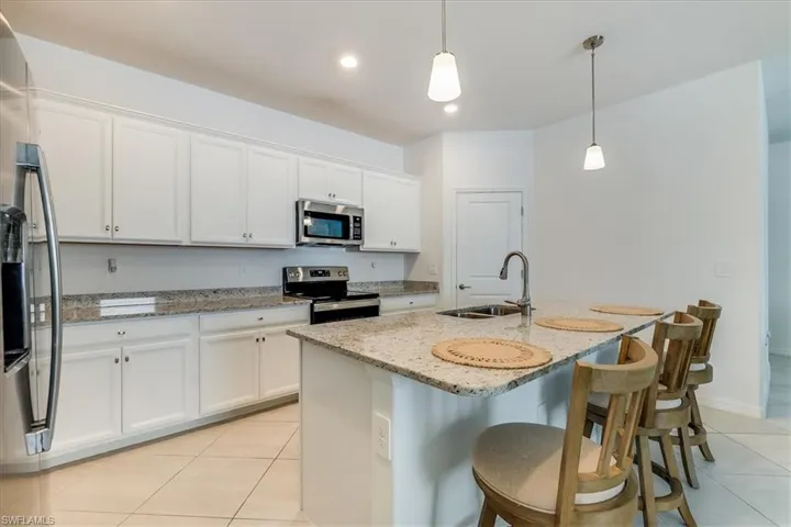 walk-in pantry, stainless appliances and pendant lighting.
