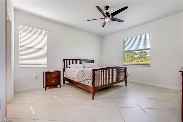 Tiled bedroom with ceiling fan