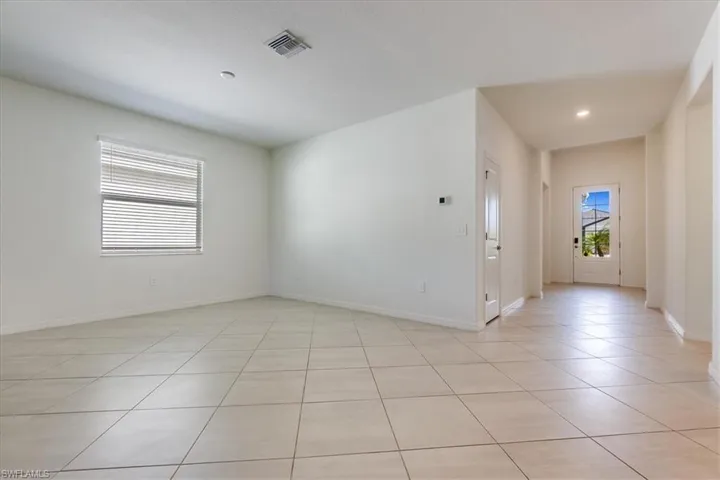 View of tiled dining room and front door.