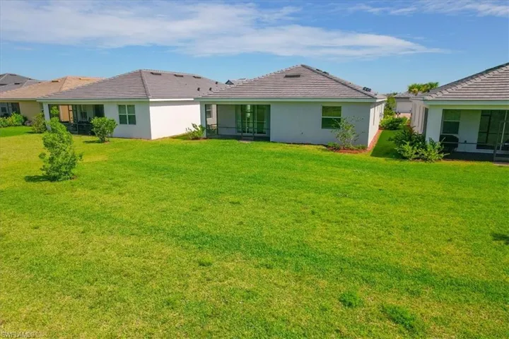 Back of house featuring a spacious yard.