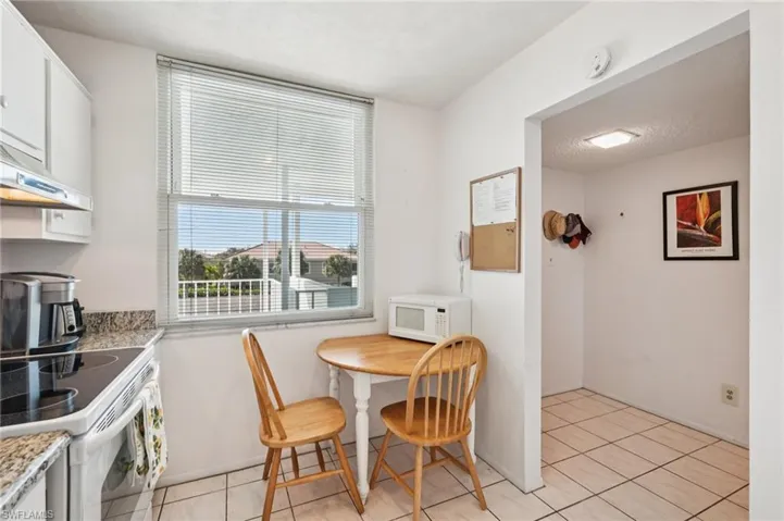 Dining area with light tile patterned floors