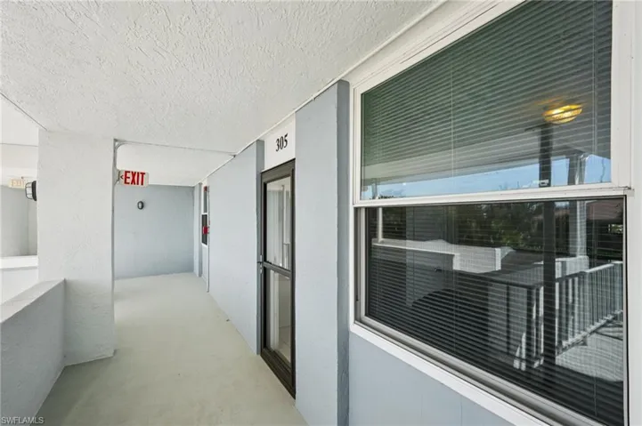 Hallway with a textured ceiling and concrete flooring
