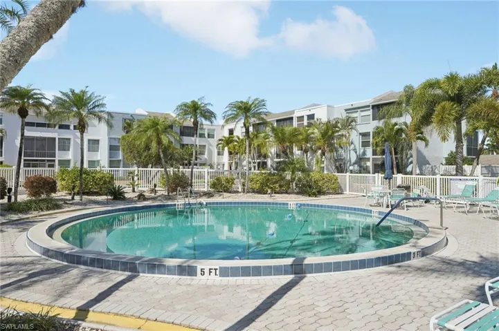 Community pool with a patio