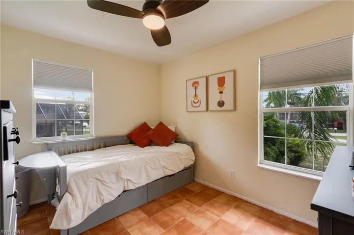 Interior room featuring warm-toned walls and square tile flooring