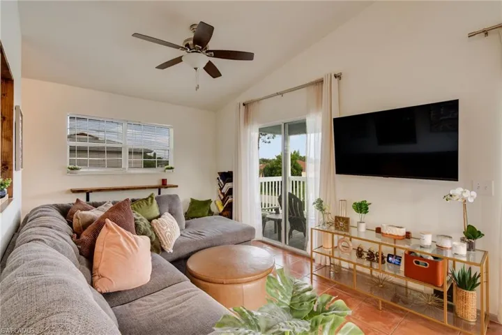 Spacious living area featuring vaulted ceilings and tile flooring