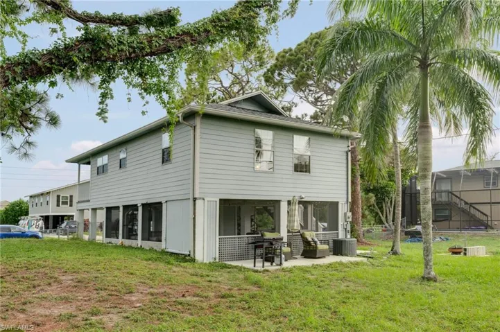 Two-story residence featuring light gray siding and a gray roof