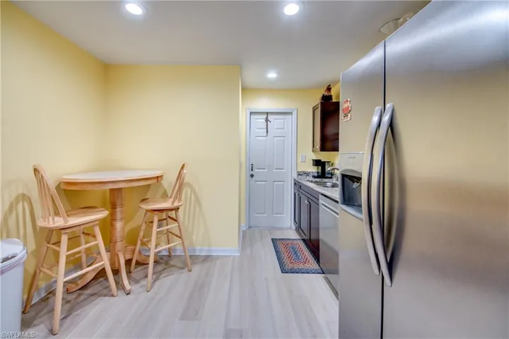 Kitchen with sink, light hardwood / wood-style floors, and appliances with stainless steel finishes