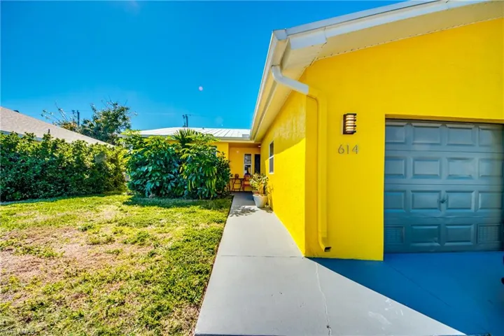 Doorway to property with a yard