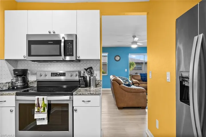 Kitchen with white cabinets and stainless steel appliances