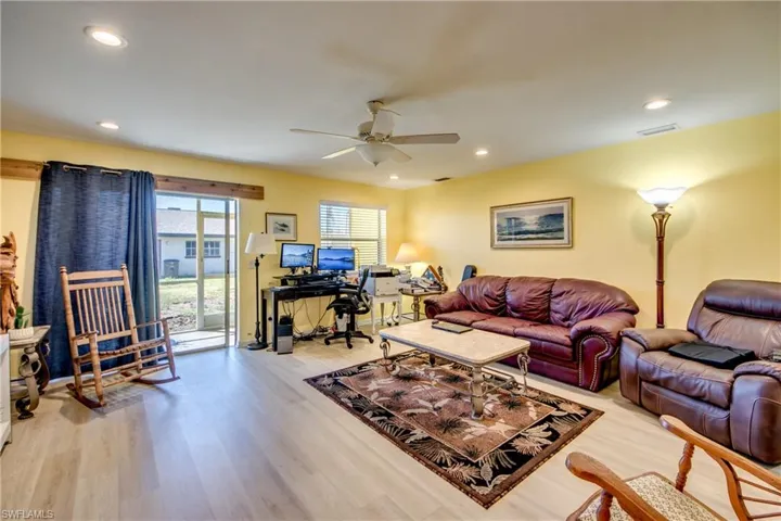 Living room featuring ceiling fan and light hardwood / wood-style floors