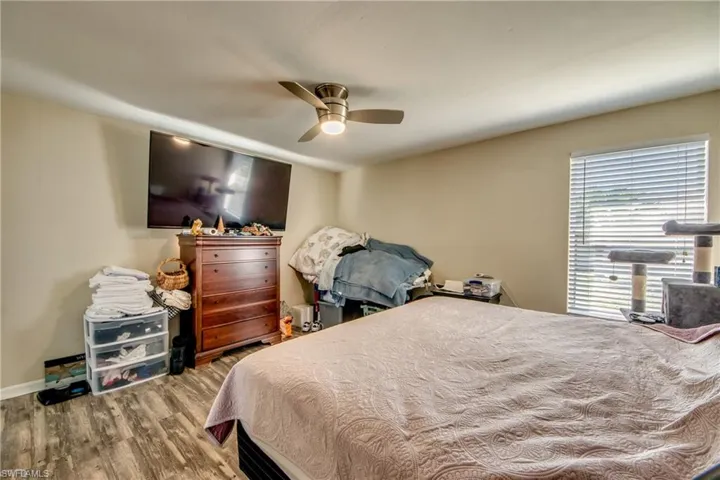 Bedroom with hardwood / wood-style flooring and ceiling fan