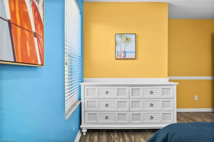 Bedroom with dark hardwood / wood-style floors