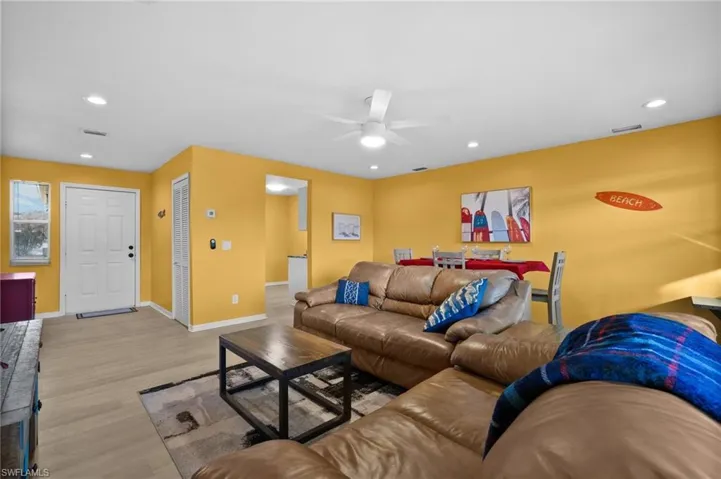 Living room featuring ceiling fan and light hardwood / wood-style flooring