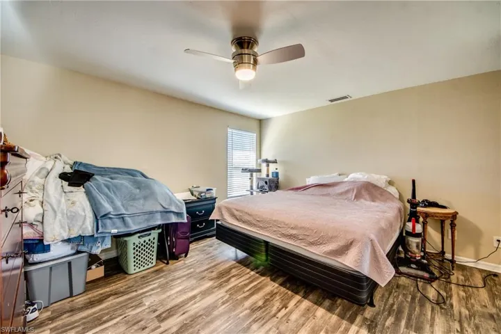 Bedroom with ceiling fan and wood-type flooring