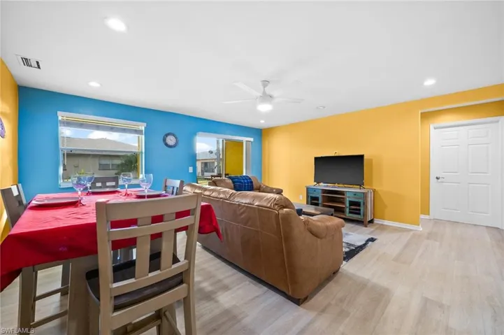 Living room with light wood-type flooring and ceiling fan