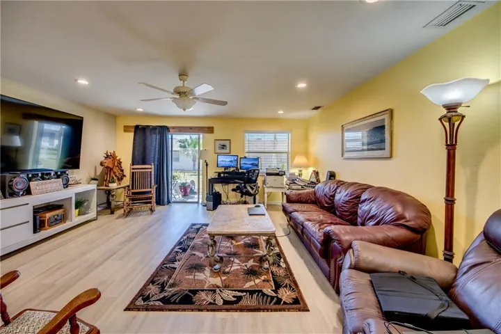 Living room featuring ceiling fan and light wood-type flooring